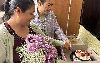 bride and groom cut their wedding cake in a hospital room at Highland Hospital